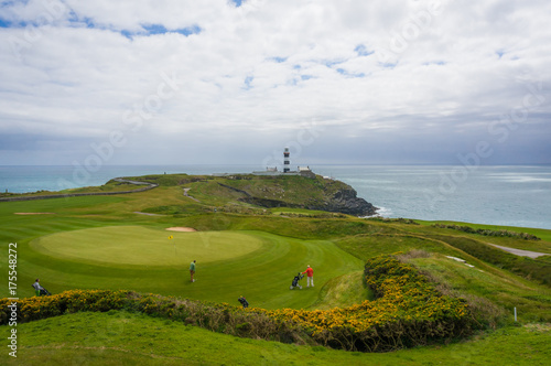 Golfers at 18th green, Old Head Golf Club in Kinsale, County Cork
