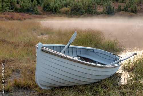 Obraz na płótnie Rowboat at edge of mist-covered pond in Alaska