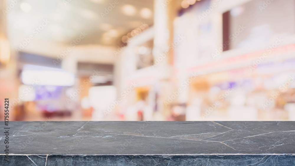 Black stone table top on blurred with bokeh shopping mall background - can be used for display or montage your products Black stone table top on blurred with bokeh shopping mall background - can be used for display or montage your products