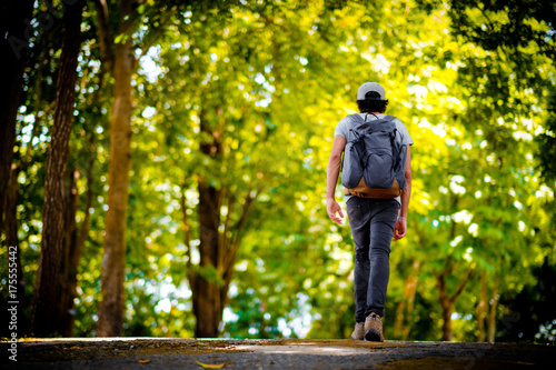 Man traveler traveling walking with backpack at the jungle on holiday at weekend on background nature view