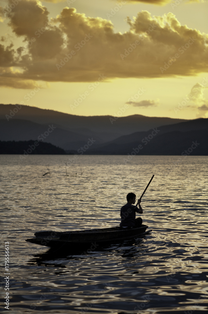 Man Pddling a Canoe