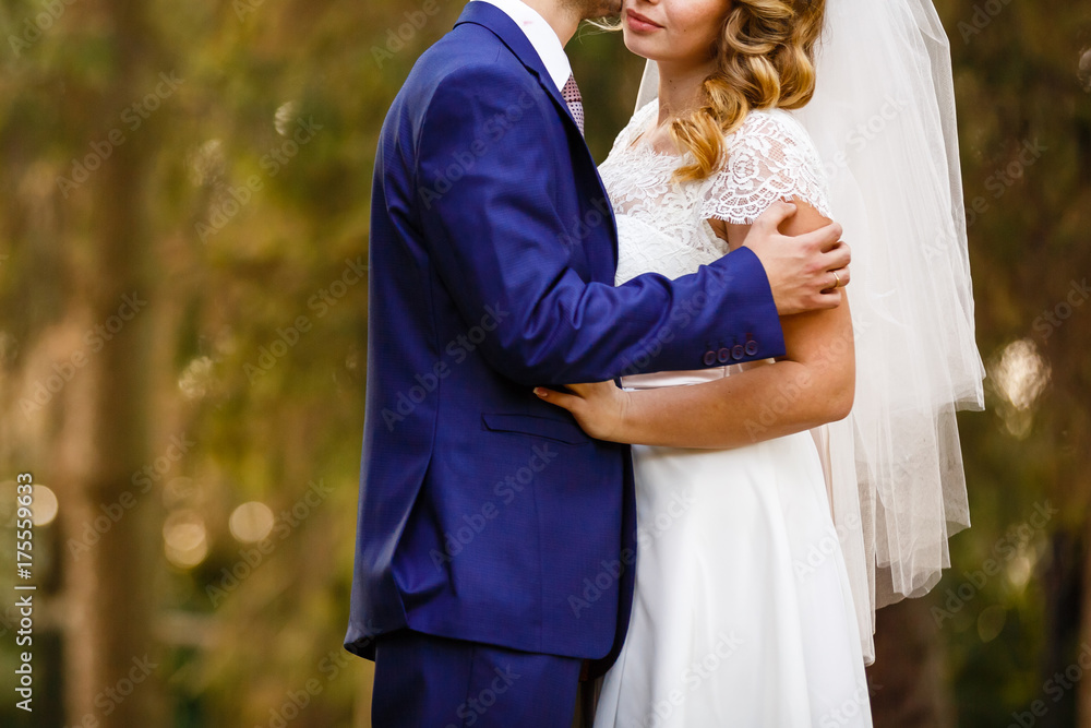 Happy bride and groom at a park on their wedding day Happy bride and groom at a park on their wedding day