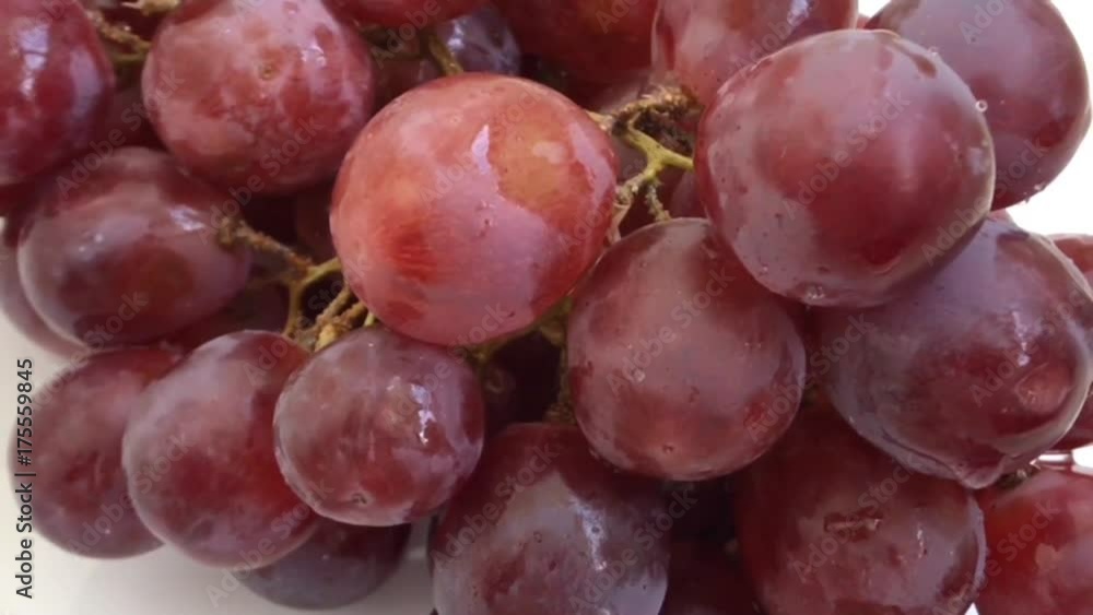 A lot Red Grapes White background wet water droplet, authentic motion rain water droplets natural fruti A lot Red Grapes White background wet water droplet, authentic motion rain water droplets natural fruti