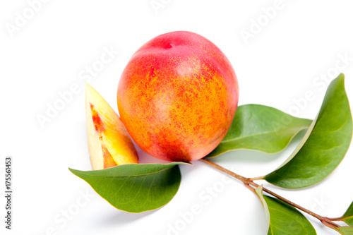 fresh peach fruits with green leaves isolated on white background