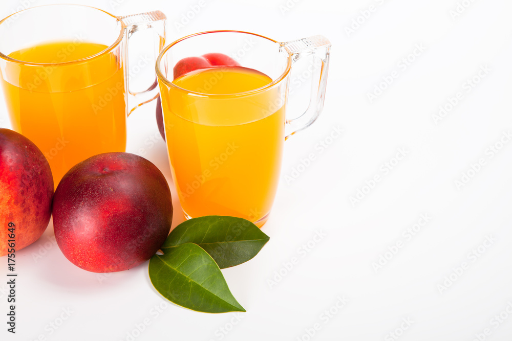 two glasses of juice and fresh peaches on white background two glasses of juice and fresh peaches on white background