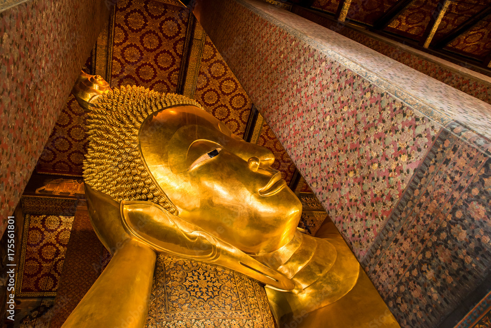 Reclining Buddha gold statue face. Wat Pho in  Bangkok, Thailand.