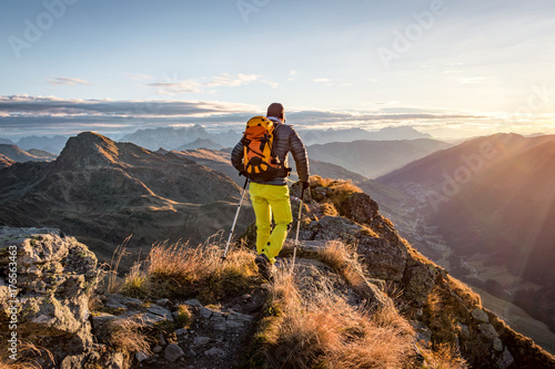 Mountaineer hiking in the mountains in morning light
