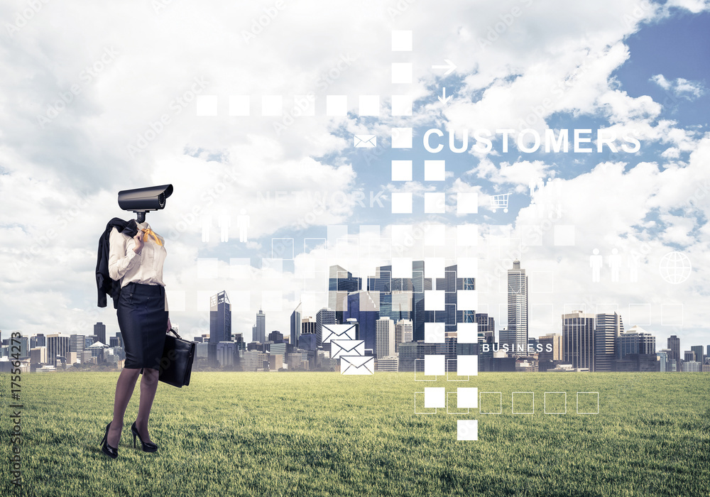 Camera headed woman standing on green grass against modern citys Camera headed woman standing on green grass against modern citys