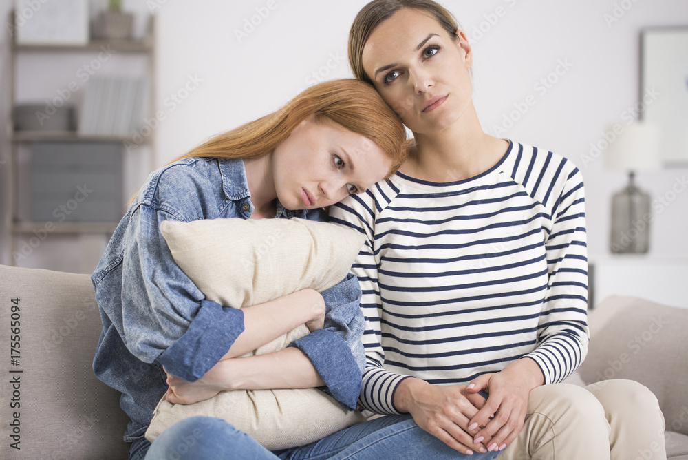 Teenage girl hugging pillow