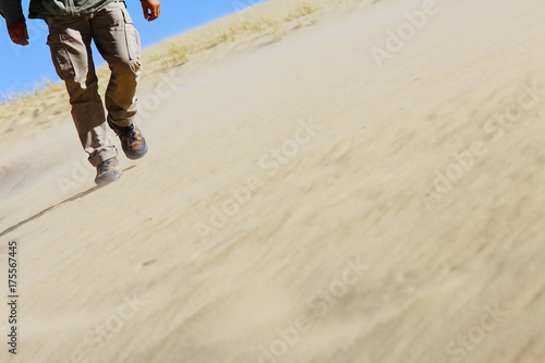 feet of a man walking in the desert