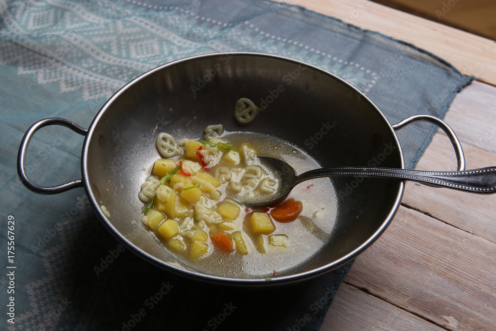 Macaroni soup with vegetables. Pasta soup in metal bowl. Macaroni soup with vegetables. Pasta soup in metal bowl.