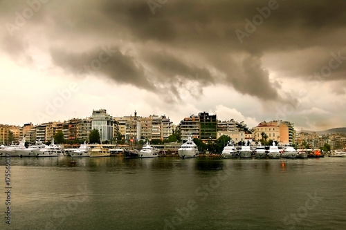 Rainy day with cloudscape.Luxury Yachts in a row at marina Zeas in Pasalimani, Piraeus port © Stratos Giannikos