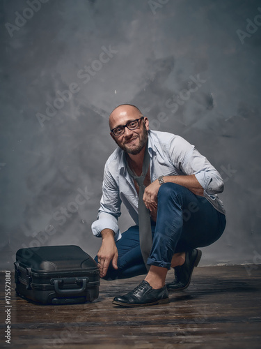 The brutal guy with his suitcase with things.