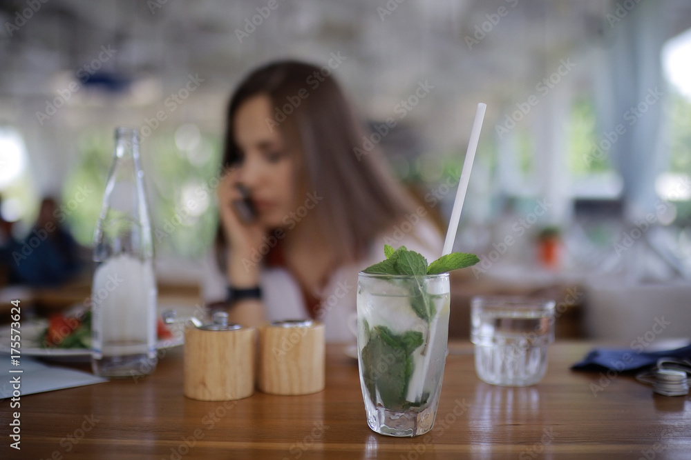 Woman having lunch in summer restaurant blurred background Woman having lunch in summer restaurant blurred background