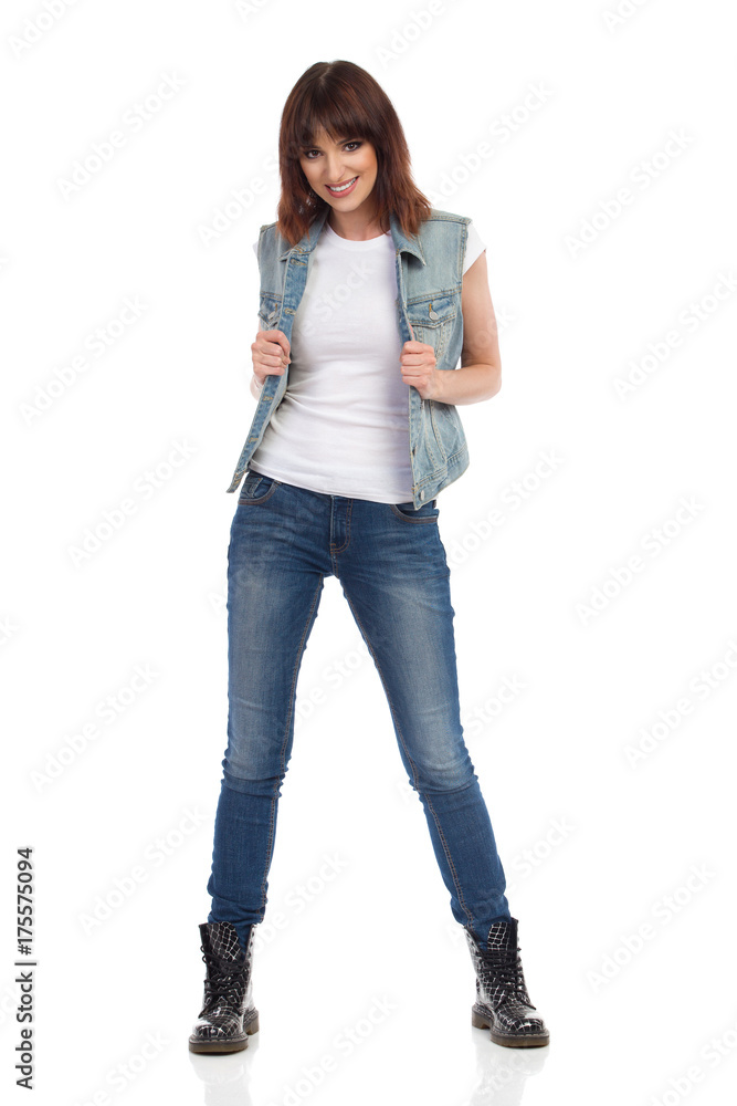 Young Smiling Woman Is Posing In Unbuttoned Jeans Vest Young Smiling Woman Is Posing In Unbuttoned Jeans Vest