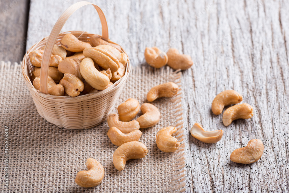 Roasted cashew nuts on rustic wood Roasted cashew nuts on rustic wood