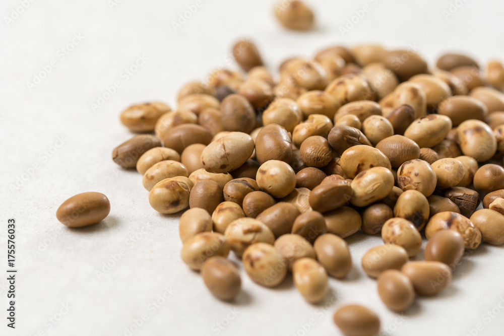 Closeup macro of soya beans on the white marble background Closeup macro of soya beans on the white marble background