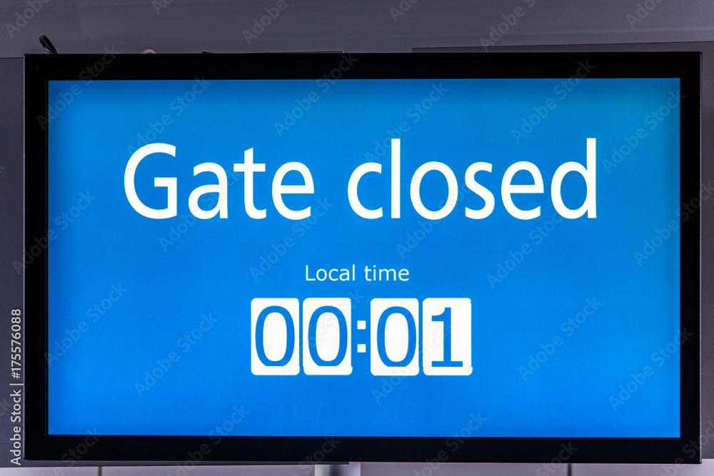 The monitor at gate at the airport. Closed gate at the terminal. The monitor at gate at the airport. Closed gate at the terminal.