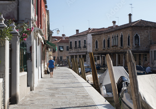 A woman walking on the street in morning  in Murano