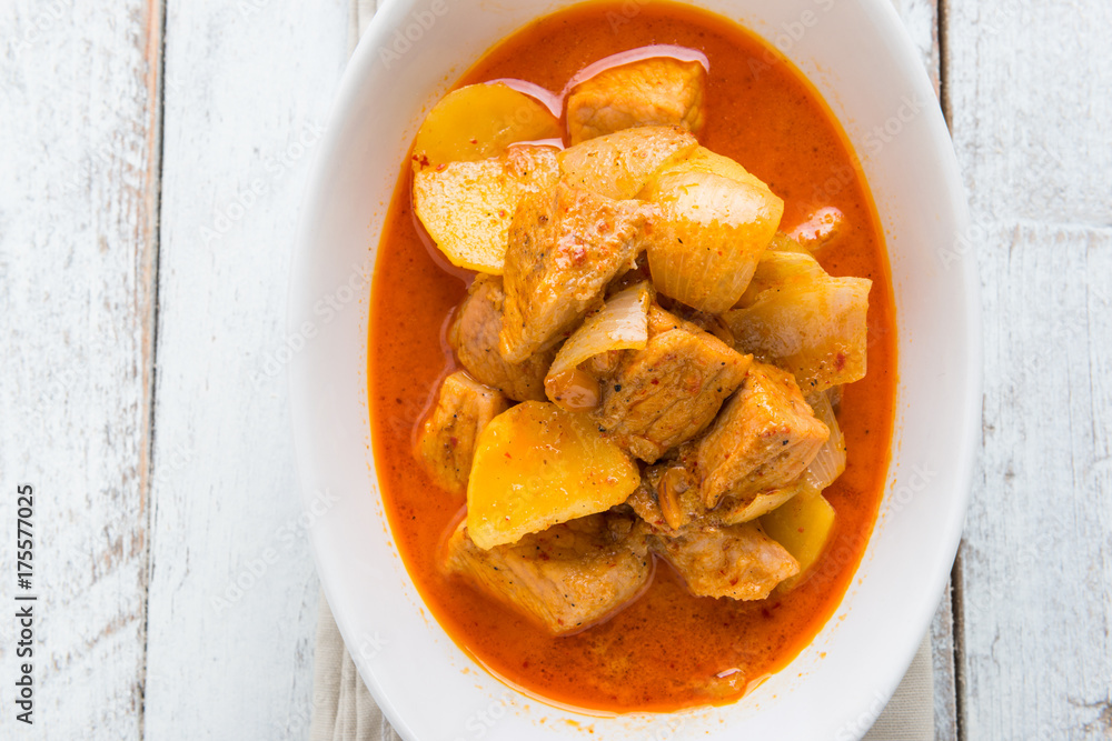 Massaman pork curry on wood background. Coconut milk curry. Massaman pork curry on wood background. Coconut milk curry.