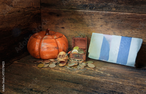 skull on coin in Halloween day concept on old vintage wooden background. still life style with copy space add text ( full High definition  Photo) © pramot48