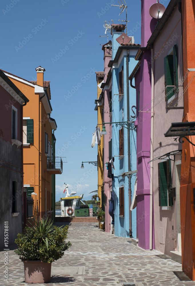 A narrow street with colourful houses in Burano, Italy