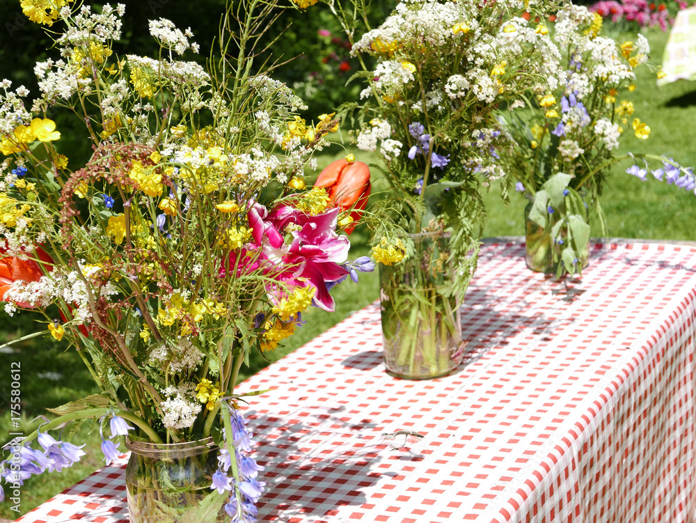 Fototapeta premium Summer garden bouquets with tulips on the garden table