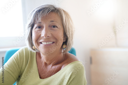 Senior woman at home relaxing in armchair