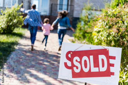 family running to new house photo