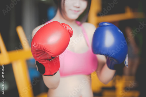 Attractive Female Punching A Bag With Boxing Gloves On © nikomsolftwaer