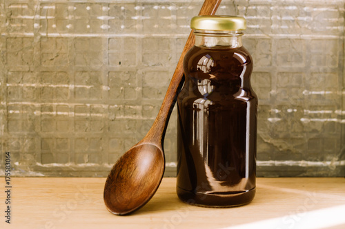 Raw Kelulut honey bee in a jar ove the wooden table photo