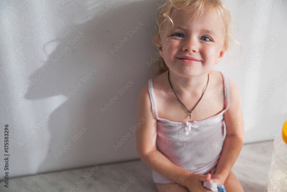 Fototapeta premium Little Caucasian Girl Cooking in Kitchen Home Early Education Development Apron Ingredients Dough Banana Pancakes Preparation