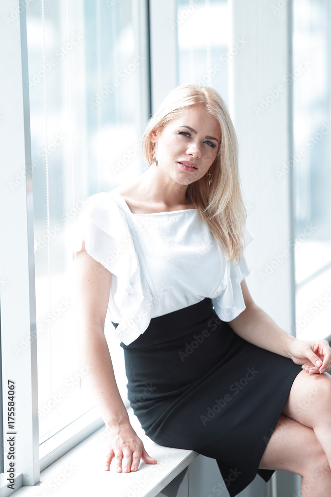 modern business woman sitting near the window in the office. modern business woman sitting near the window in the office.