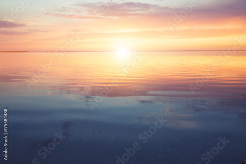 Scenic ocean sunset over the calm water surface