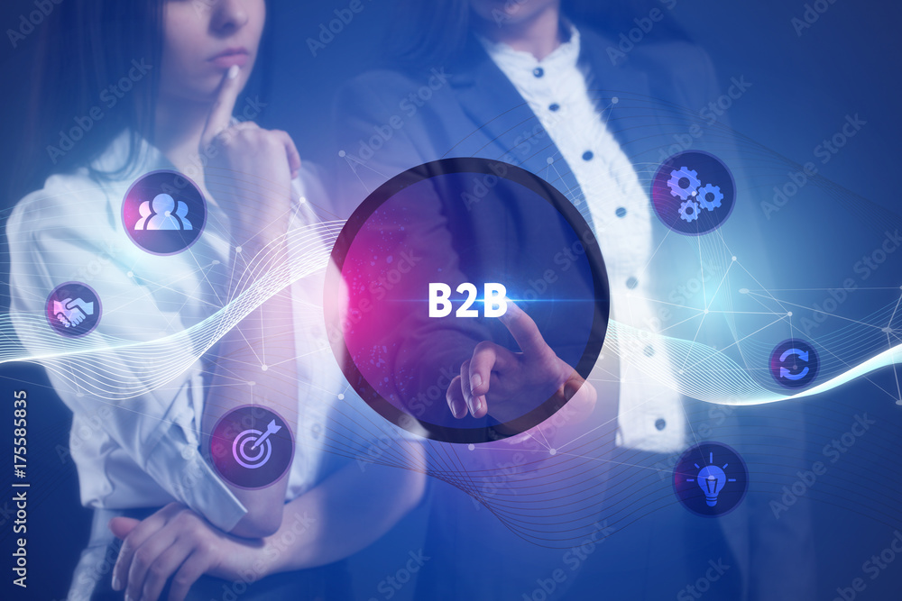 The concept of business, technology, the Internet and the network. A team of business women working on the virtual screen of the future and see the inscription: B2B The concept of business, technology, the Internet and the network. A team of business women working on the virtual screen of the future and see the inscription: B2B