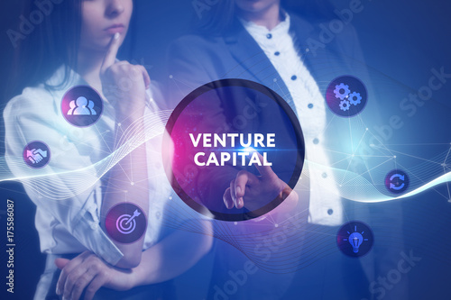 The concept of business, technology, the Internet and the network. A team of business women working on the virtual screen of the future and see the inscription: Venture capital