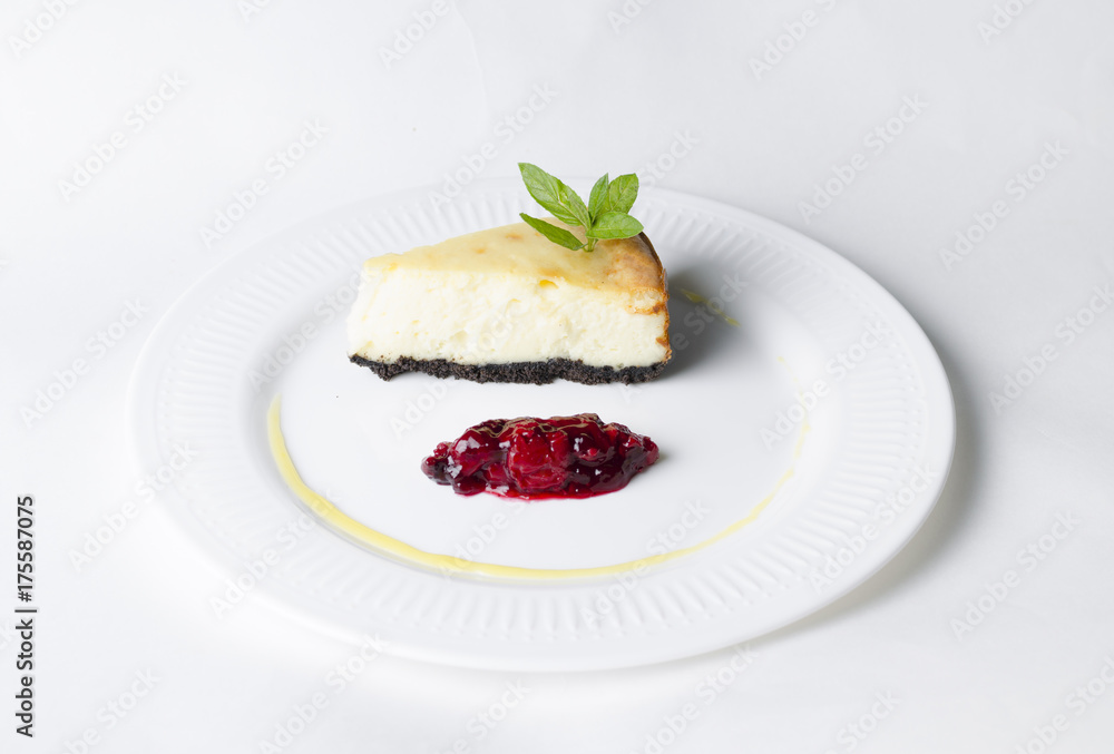 Classic cheesecake with cherry sauce on a white plate Classic cheesecake with cherry sauce on a white plate
