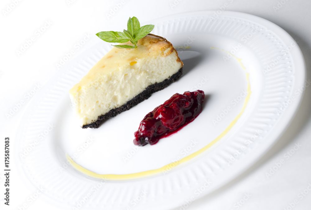 Classic cheesecake with cherry sauce on a white plate Classic cheesecake with cherry sauce on a white plate