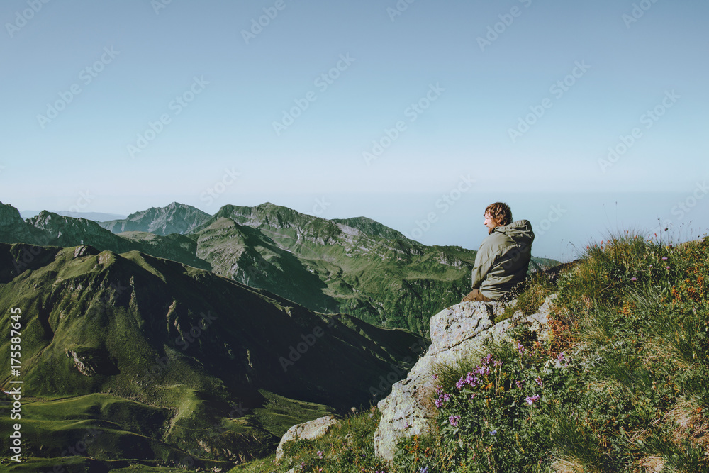 Man hiker alone at mountains enjoying landscape aerial view Travel Lifestyle concept adventure vacations outdoor