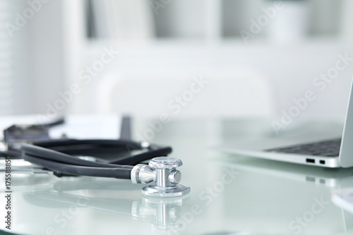 Medicine doctor's working table. Focus on stethoscope 