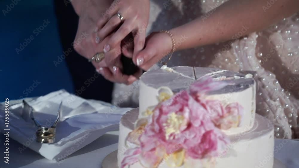 Bride and groom cutting piece of wedding cake slowmotion Bride and groom cutting piece of wedding cake slowmotion