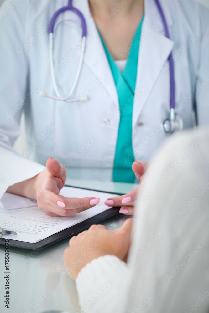 Doctor and patient, close-up of hands. Physician talking about medical examination results. Medicine, healthcare and helping concept Doctor and patient, close-up of hands. Physician talking about medical examination results. Medicine, healthcare and helping concept