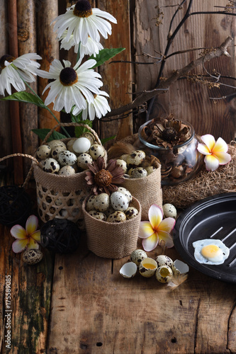 studio shot of quail eggs on a vintage wooden background.
