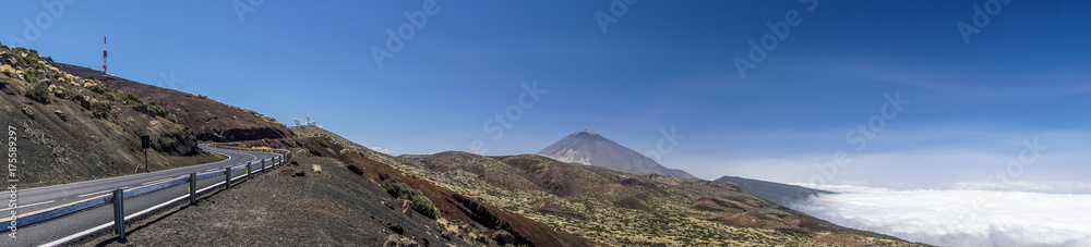 Bergstraße führt zum Teide-Observatorium auf Teneriffa als Panoramabild mit Vulkan Teide und Wolkenteppich im Hintergrund Bergstraße führt zum Teide-Observatorium auf Teneriffa als Panoramabild mit Vulkan Teide und Wolkenteppich im Hintergrund