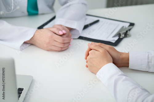 Doctor and patient  close-up of hands.  Physician talking about medical examination results. Medicine  healthcare and helping concept