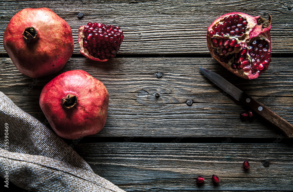 Fresh pomegranates on a wooden background. Organics, fruit, food Fresh pomegranates on a wooden background. Organics, fruit, food