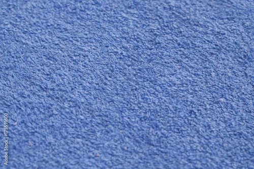 Blue color towel surface close-up with blur effect.