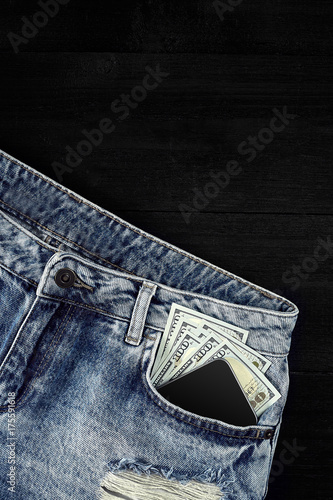 Cash and smart in your jeans pocket. Still life. photo