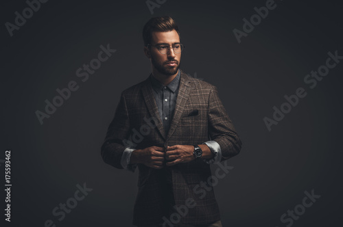 Sophisticated man adjusting jacket
