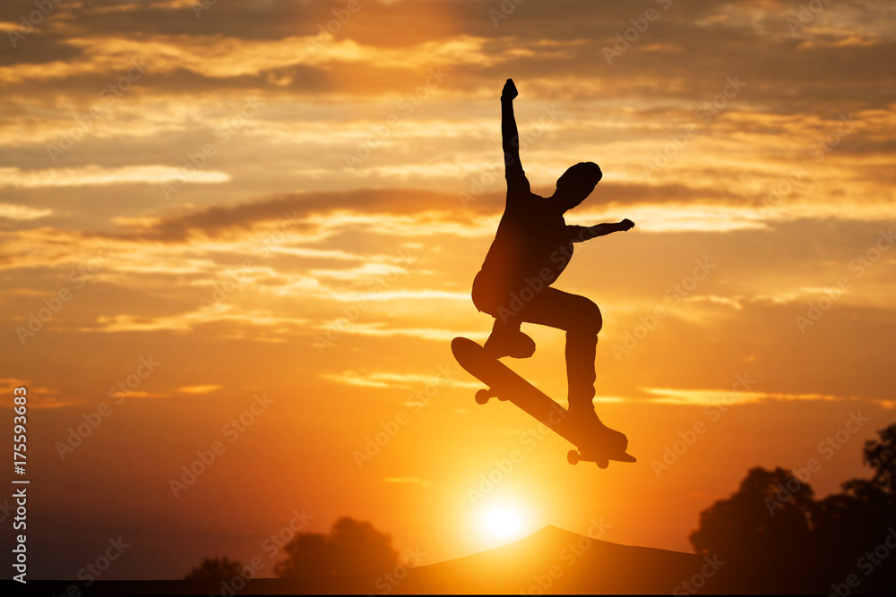 Skateboarder jumping at sunset.